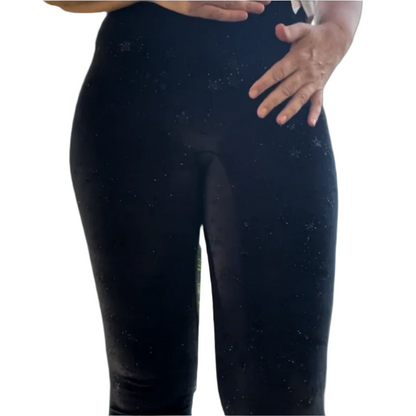 A pair of black velvet leggings with a high waist, featuring a pattern of glistening stars.